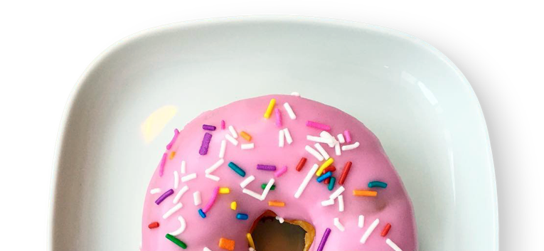 A vanilla sprinkles doughnuts on a plate